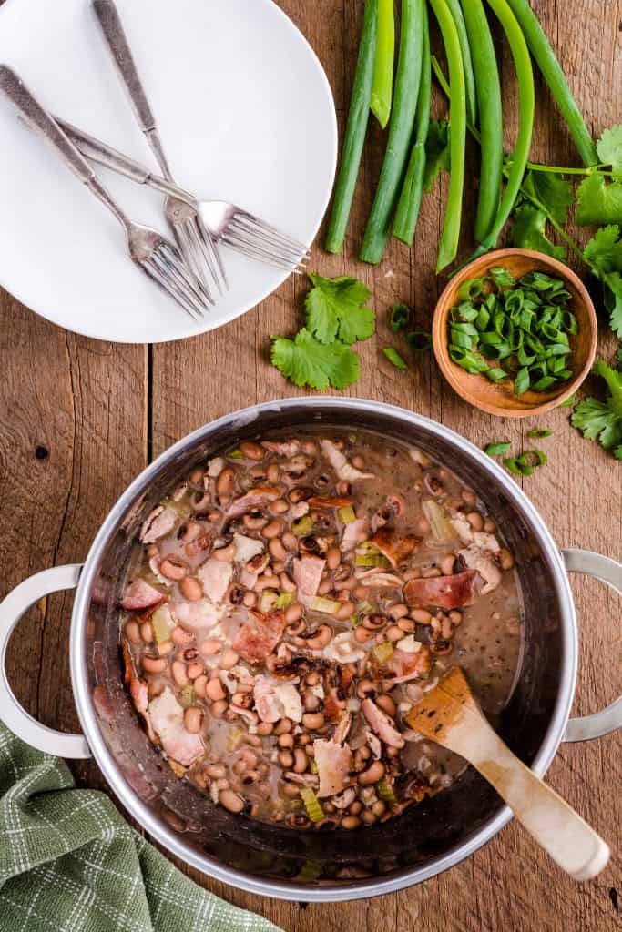 Overhead view of cooked black eyes peas in a stock pot.