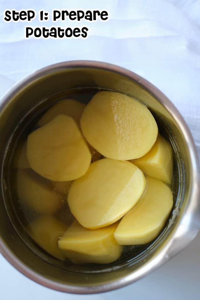 Sliced potatoes in a large pot of water.