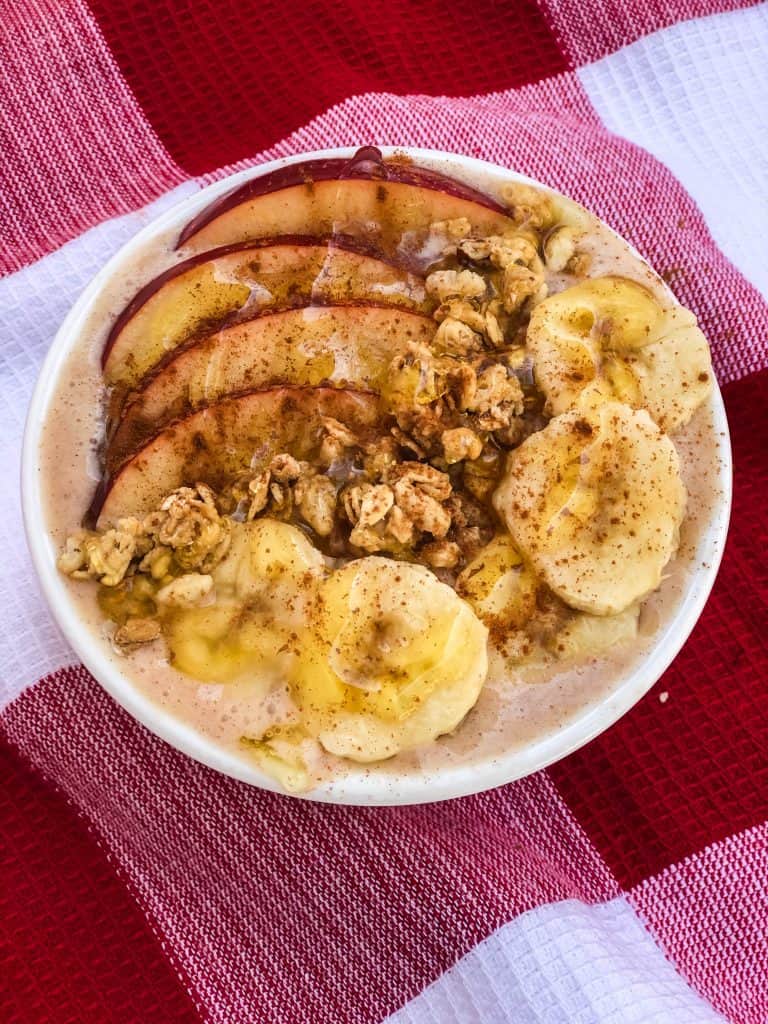 Overhead shot of cinnamon banana apple smoothie bowl.
