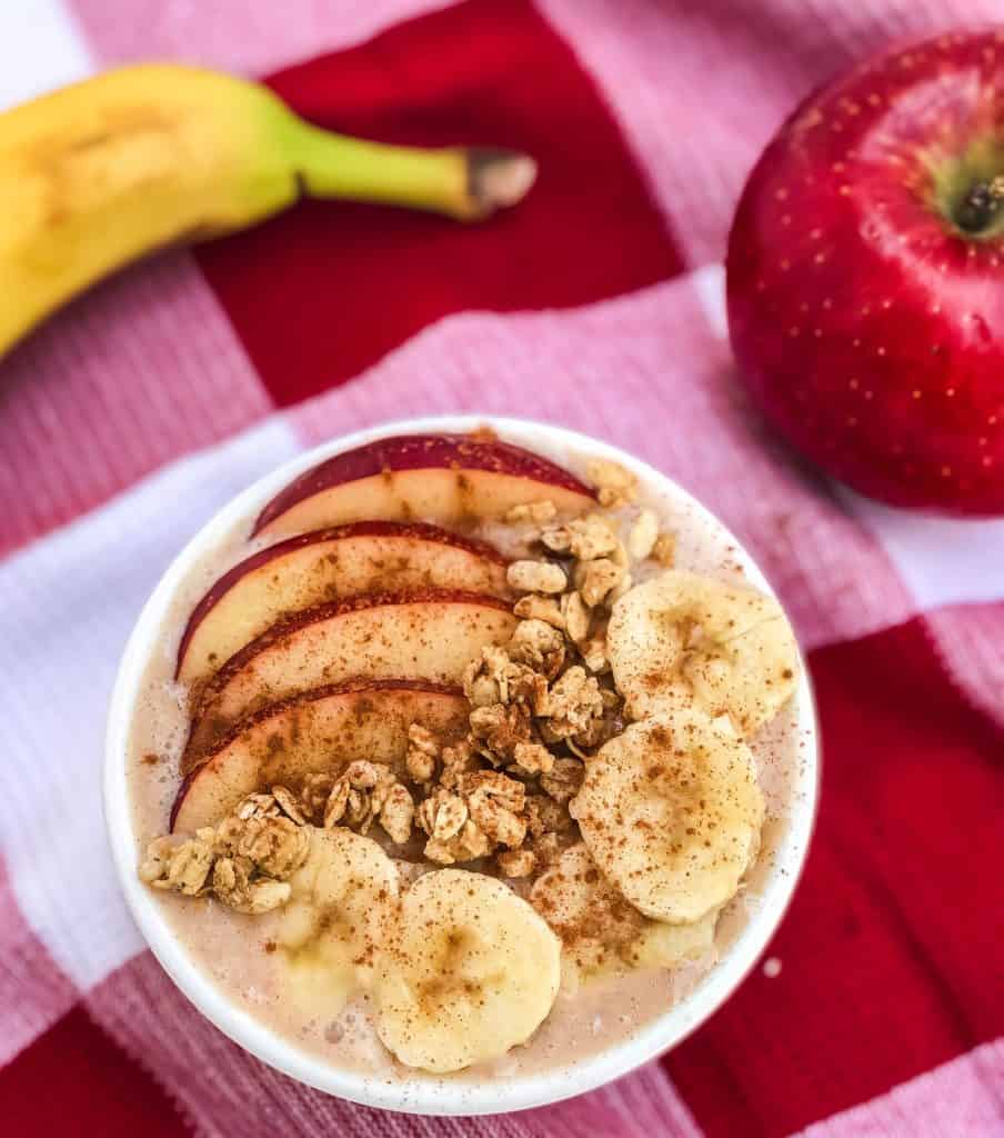 Cinnamon apple banana smoothie bowl with cinnamon sprinkled on top.