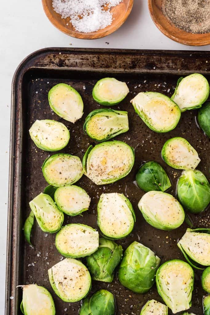 Sporuts on baking sheet seasoned with salt and pepper.