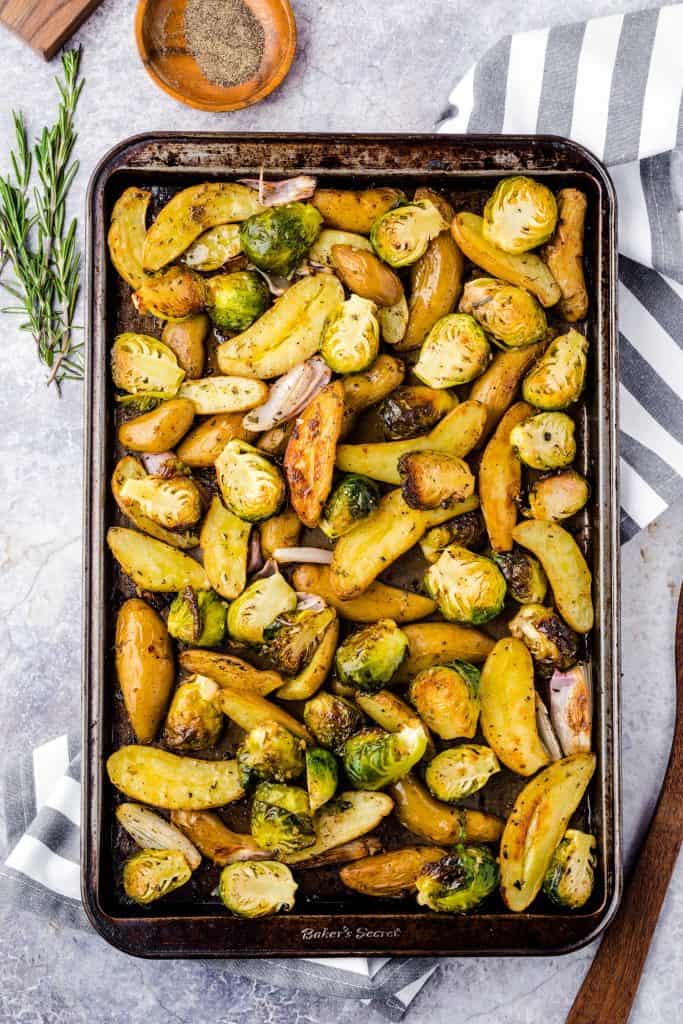 Roasted potatoes and sprouts on a baking sheet.