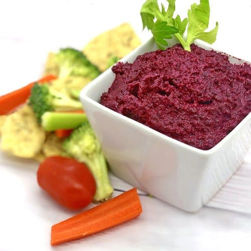 Beet Hummus with Veggies on a white background