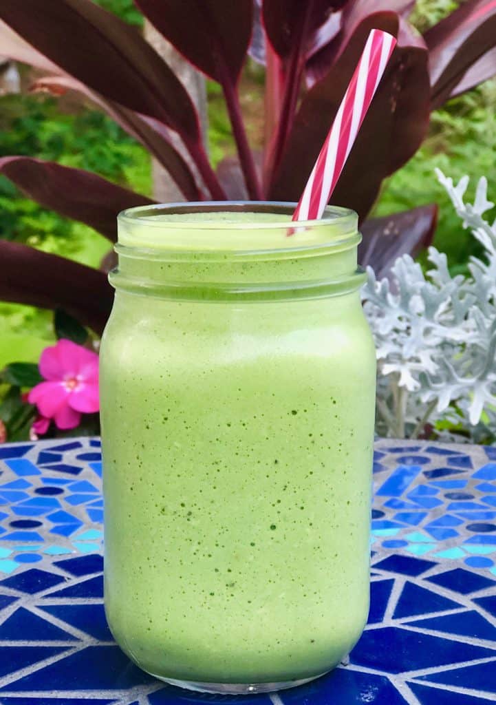 Tropical Green Smoothie with a blue tilebacground
