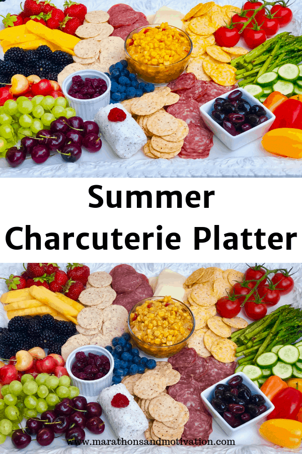 A charcuterie platter with fresh fruits, vegetables, and cured meats