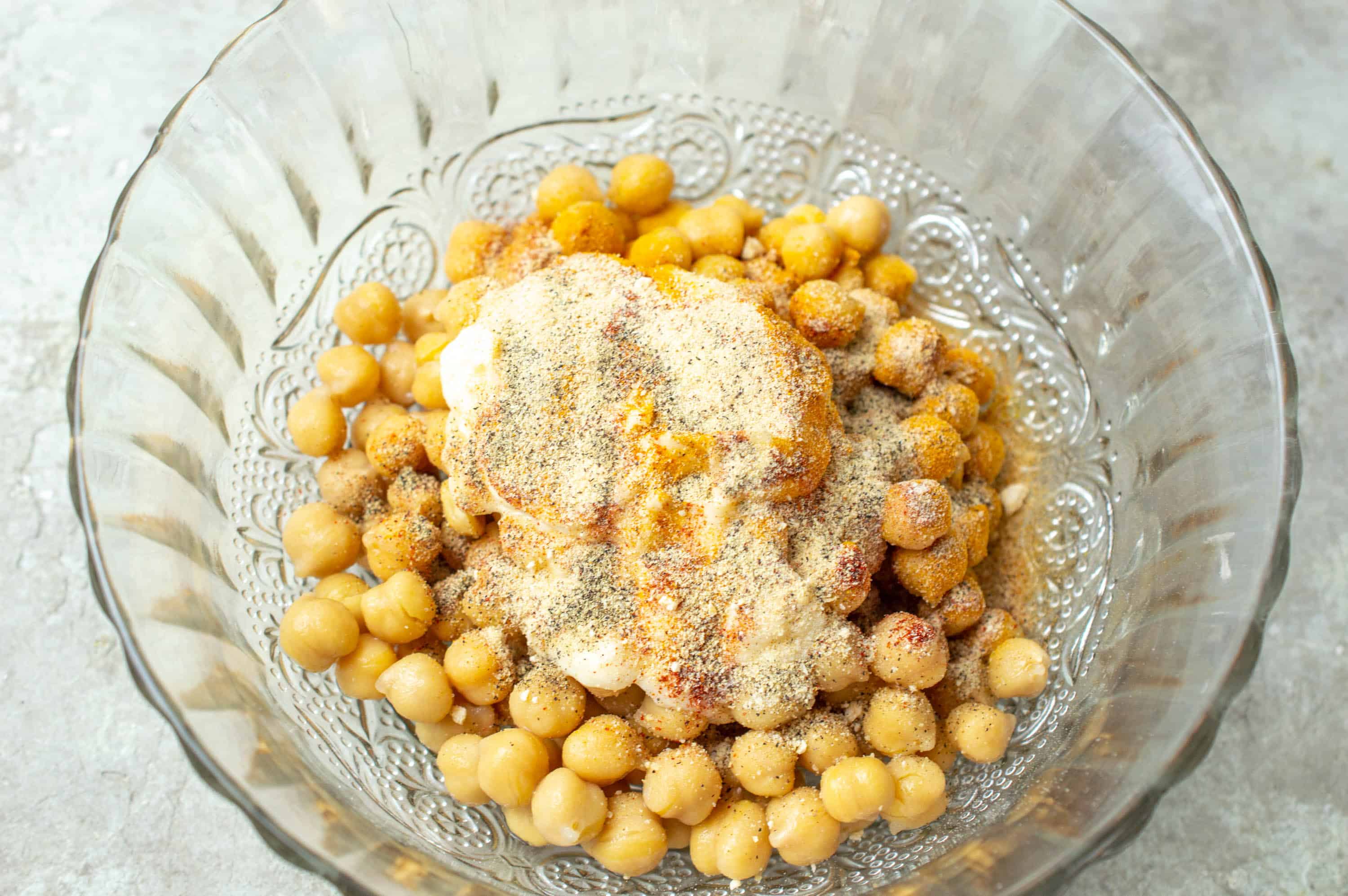 chickpeas in bowl with mayonnaise and spices