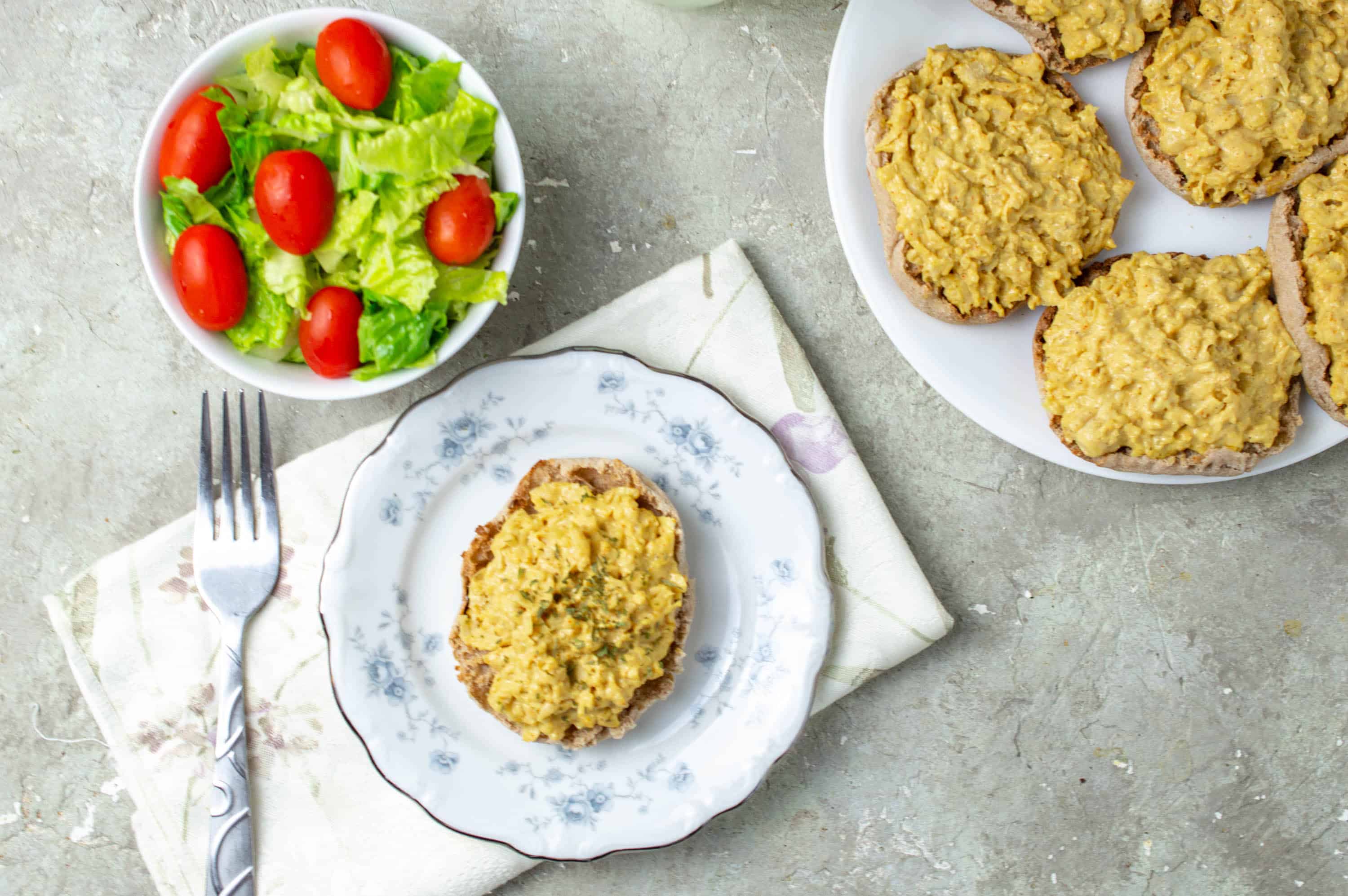 vegetarian chicken salad on a plate with a side salad and fork
