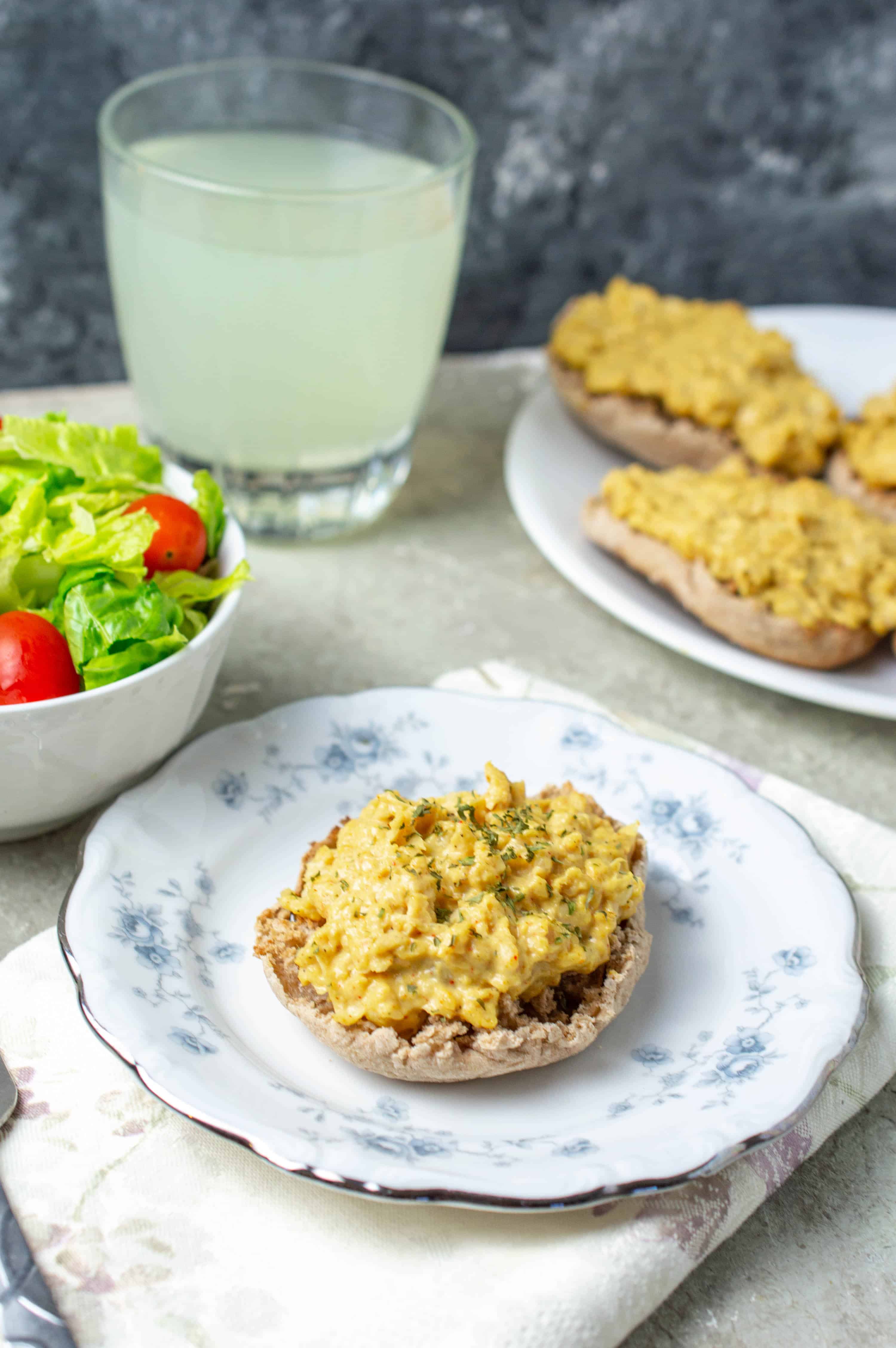 Vegetarian Chicken salad on a plate with a side salad and lemonade