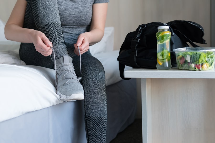 Female athlete getting ready for athletic and fitness training. Drinks, diet, detox and people concept healthy eating. Sport and exercise.