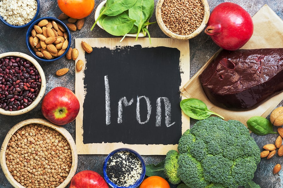 Foods high in iron. Vegetables, fruits rich in iron on a rustic background. Top view, flat lay, copy space