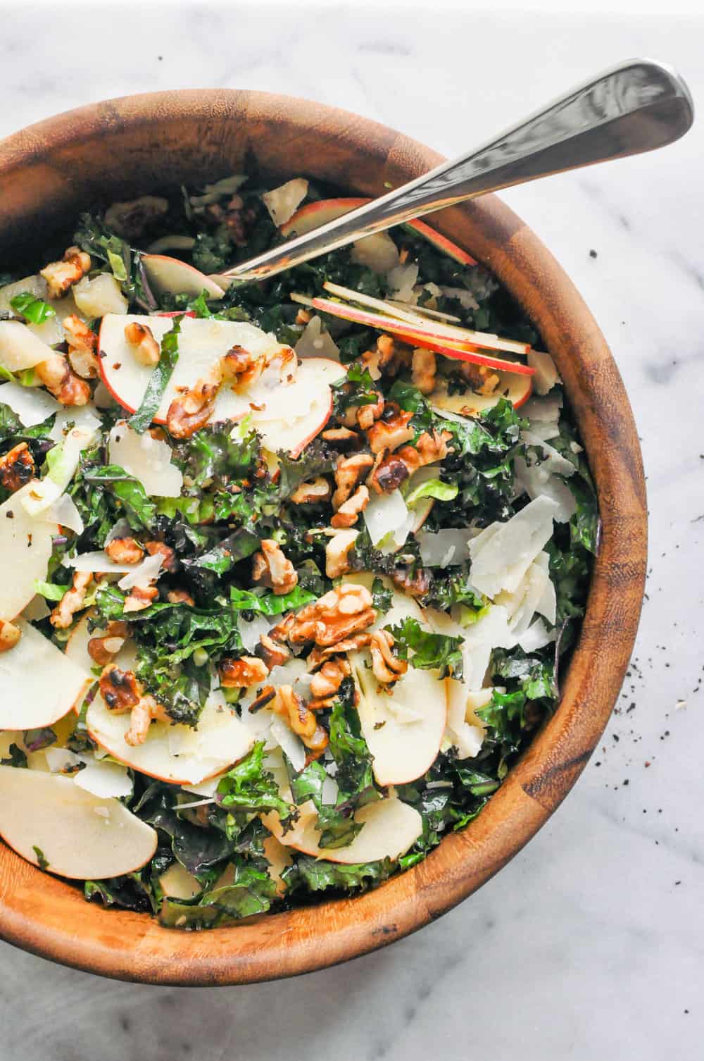 Shredded Brussels Sprouts, Kale and Apple Salad in a wooden bowl