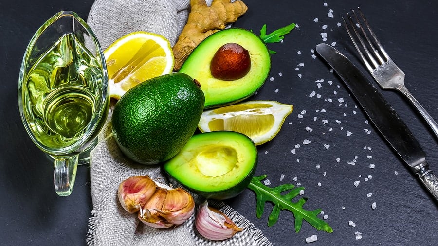 Green ripe avocado, avocado oil. healthy food. raw produce. Copy space Top view.