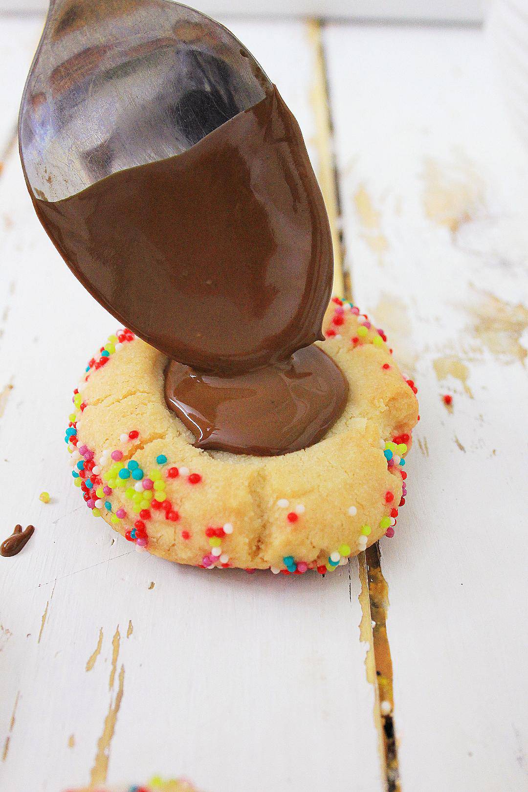 Adding chocolate thumbprint to cookie