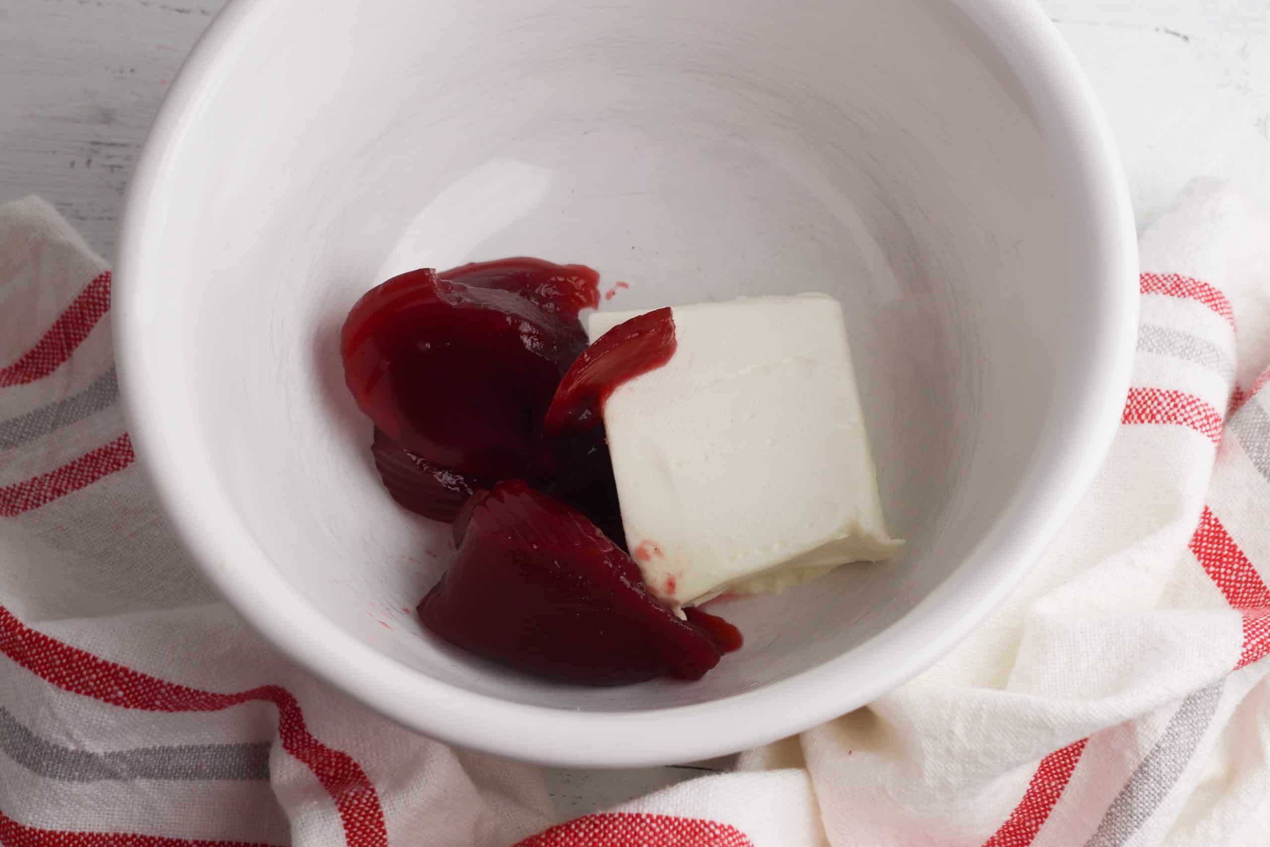 Cranberry and cream cheese in a white bowl.