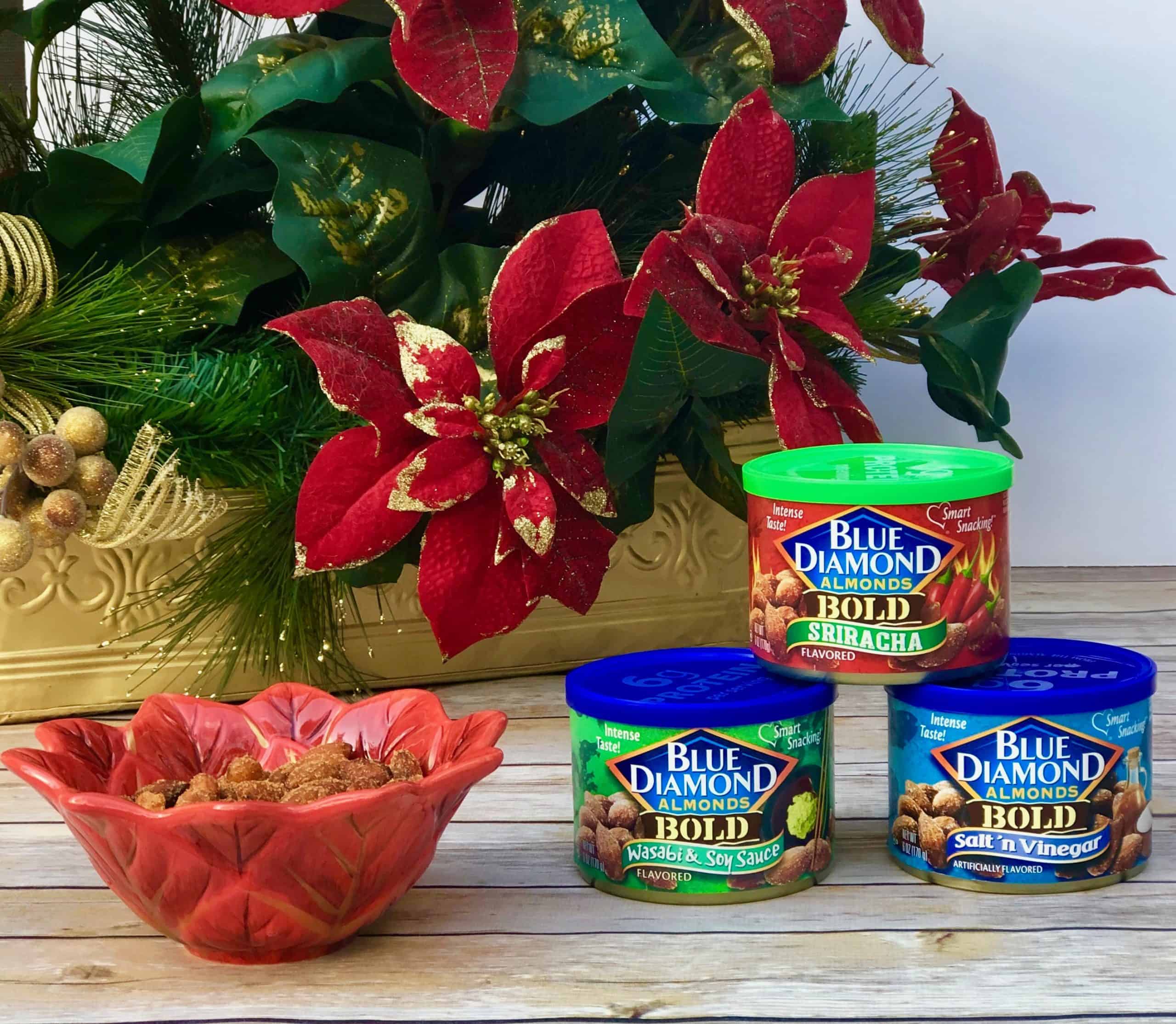 Blue Diamond Almonds in cans and in holiday bowl with poinsettias in background.