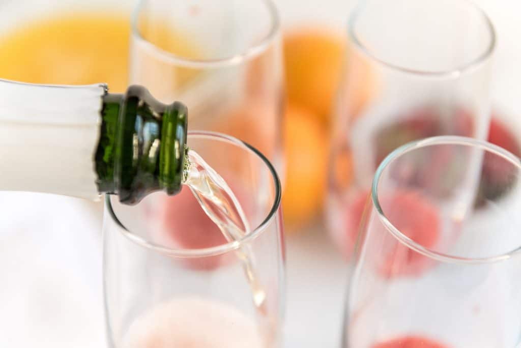 Pouring champagne into a flute.