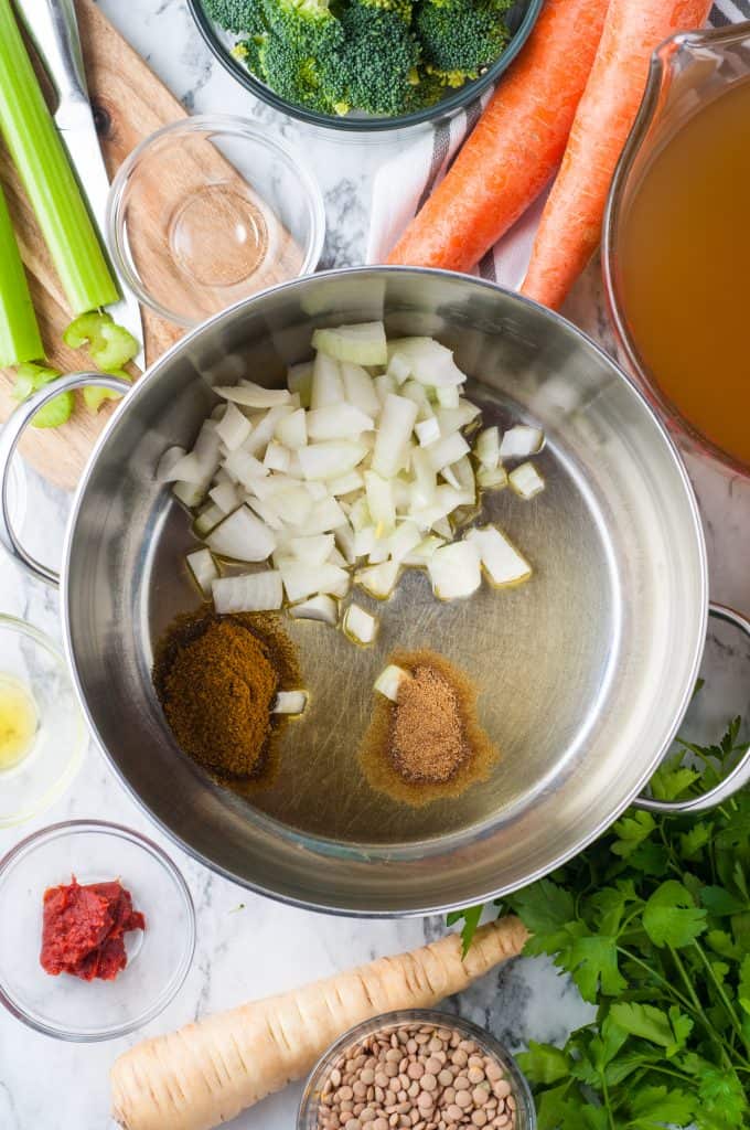 Onions, curry and cumin in a sauce pan.