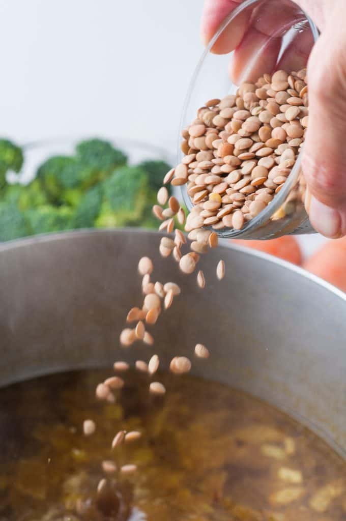 Lentils being poured into a pot