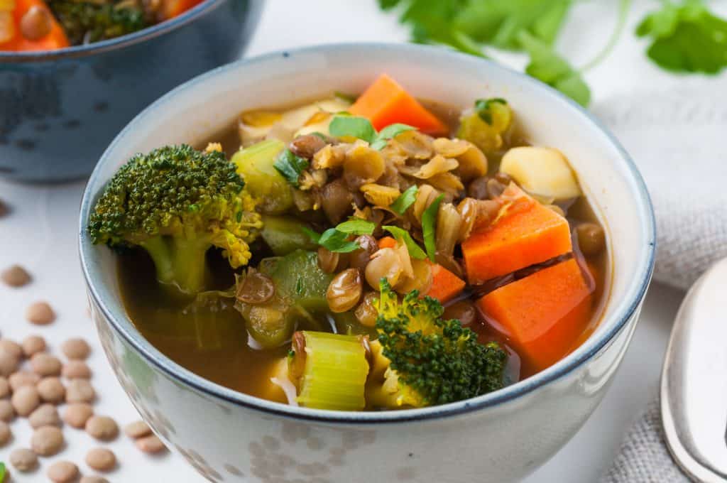 Vegan lentil soup in a white bowl.