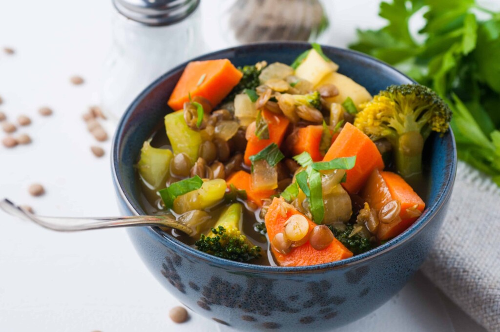 vegan lentil soup in a blue serving bowl.