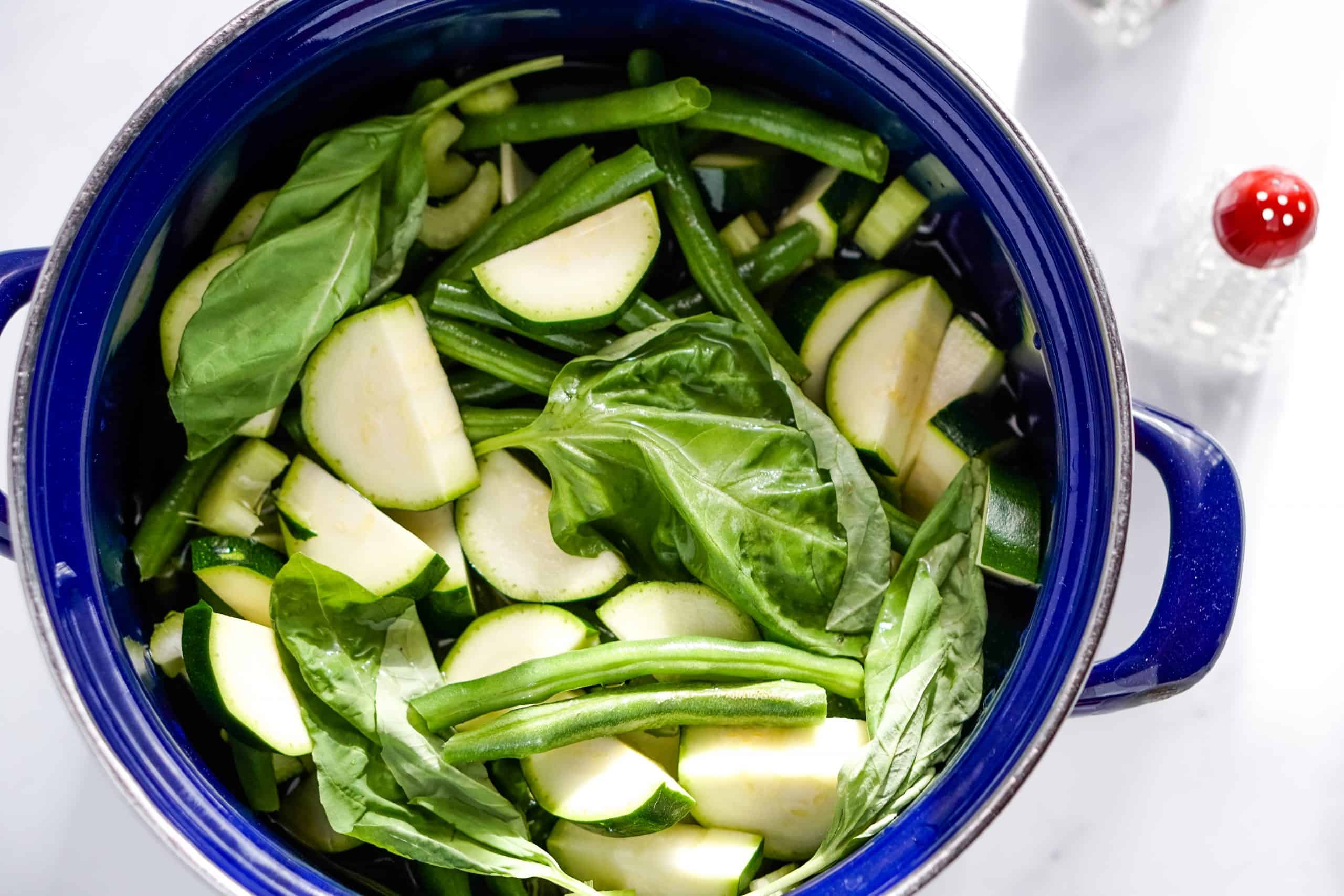 green vegetables in a blue ceramic pot.
