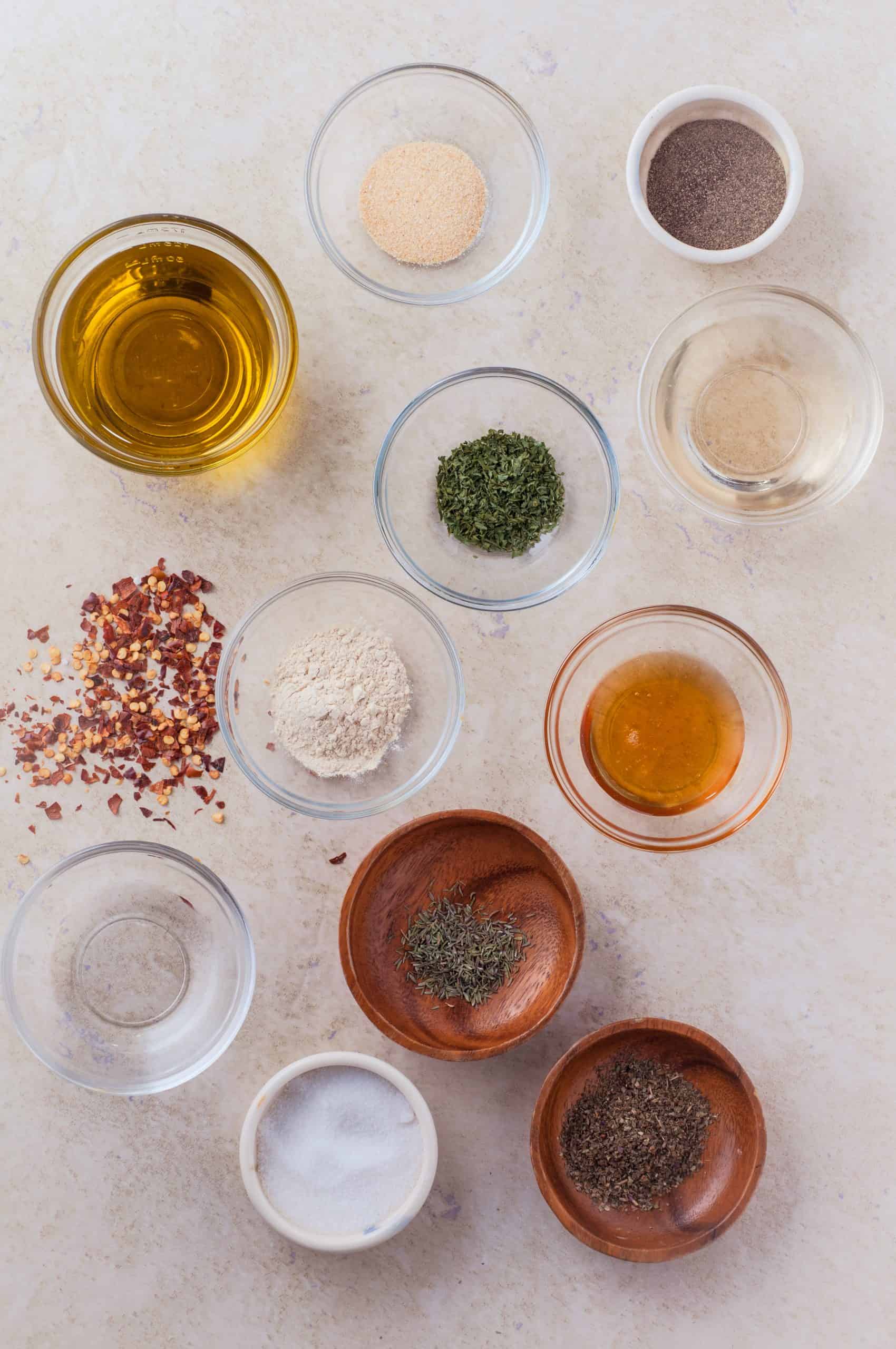 Ingredients for Italian dressing on a beige background.