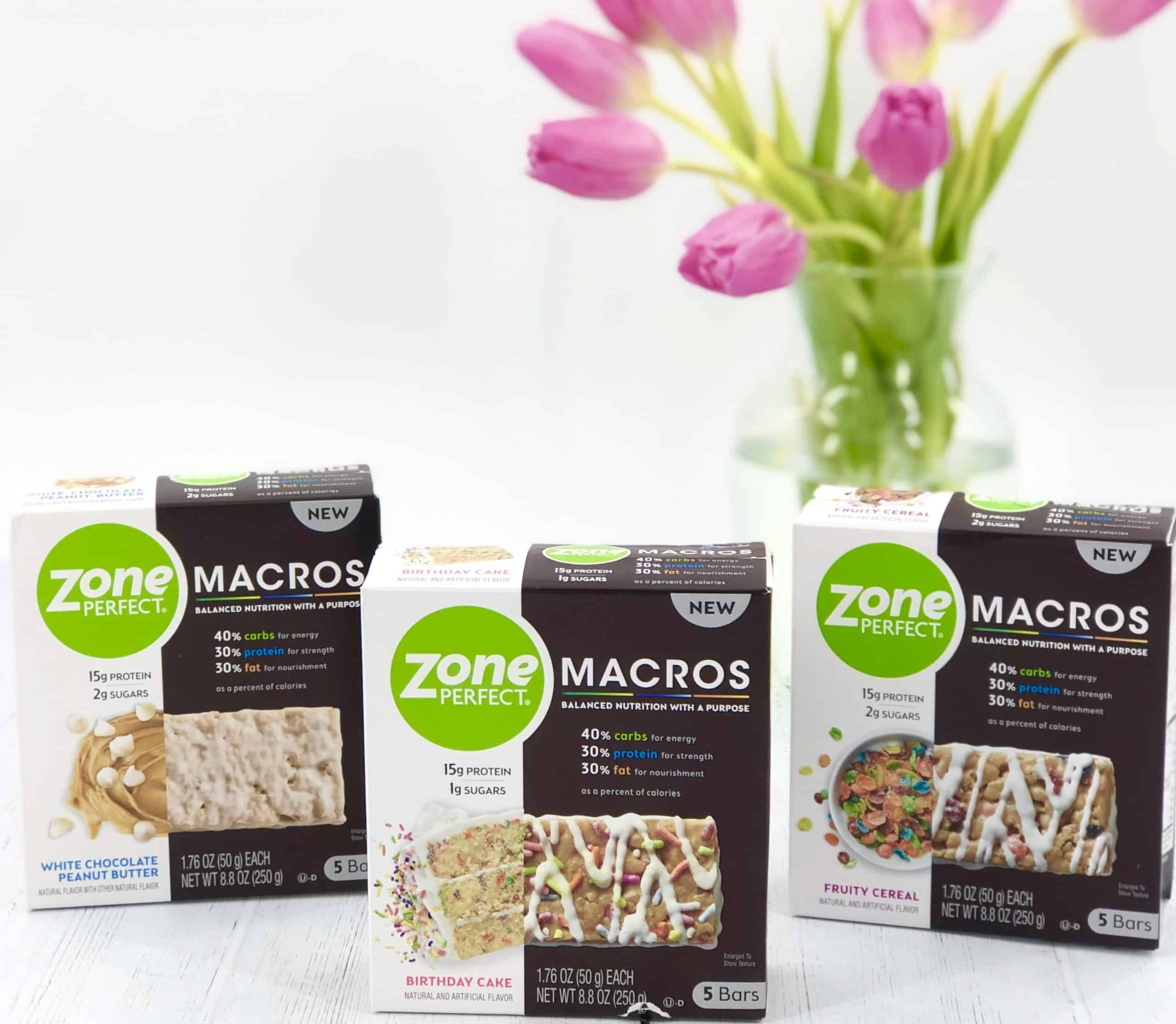 Zone Perfect Macro Bars on white table with pink tulips in the background.