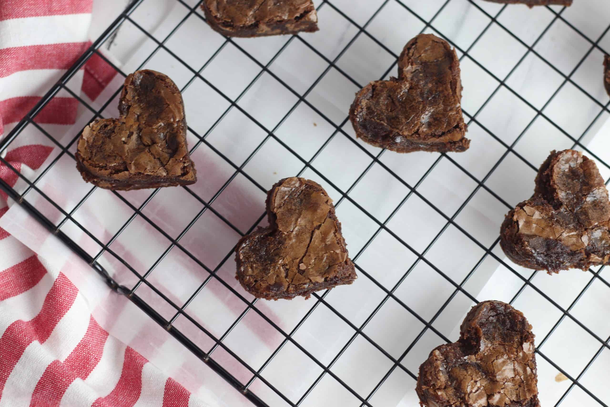Heart shaped brownies on a wire rack.