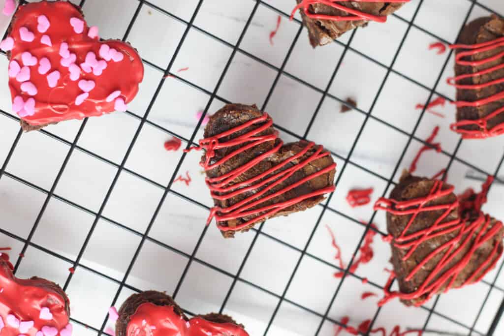 Decorated brownies on a wire baking rack.