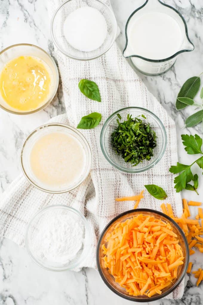 Baking ingredients on white marble background.