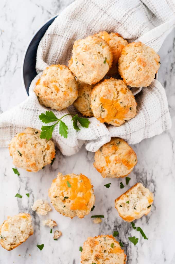 Cheese scones on a white marble background.