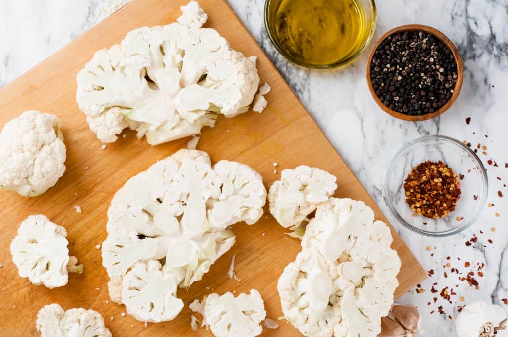 Cauliflower slices on a cutting board.