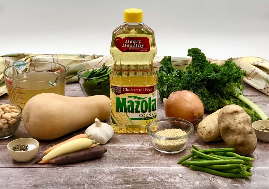 Ingredients for Minestrone on a wood background with a bottle of Mazola Corn Oil in the center.