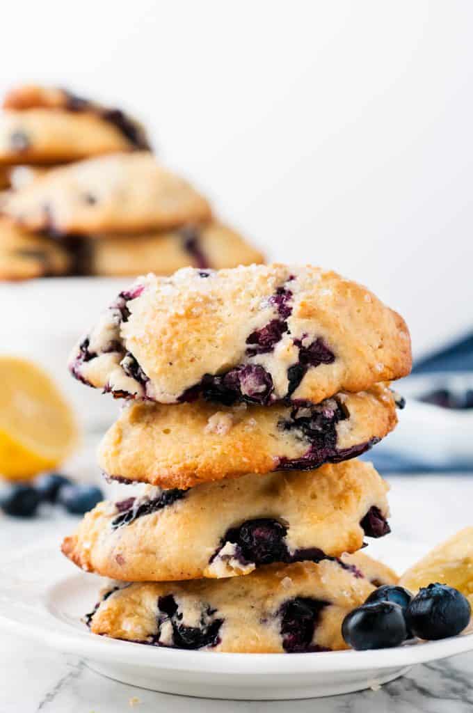 Stacked blueberry scones on a white plate.