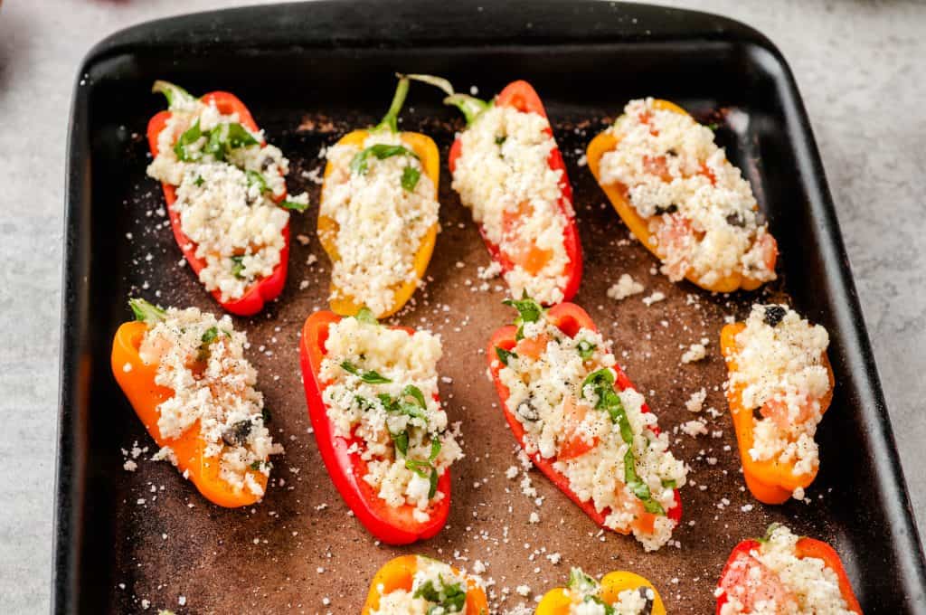 stuffed mini peppers on a baking sheet