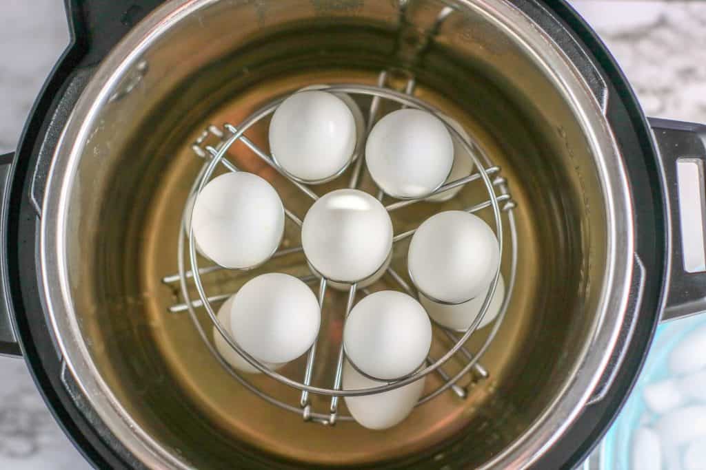 Overhead view of eggs in a trivet inside of an Instant Pot.