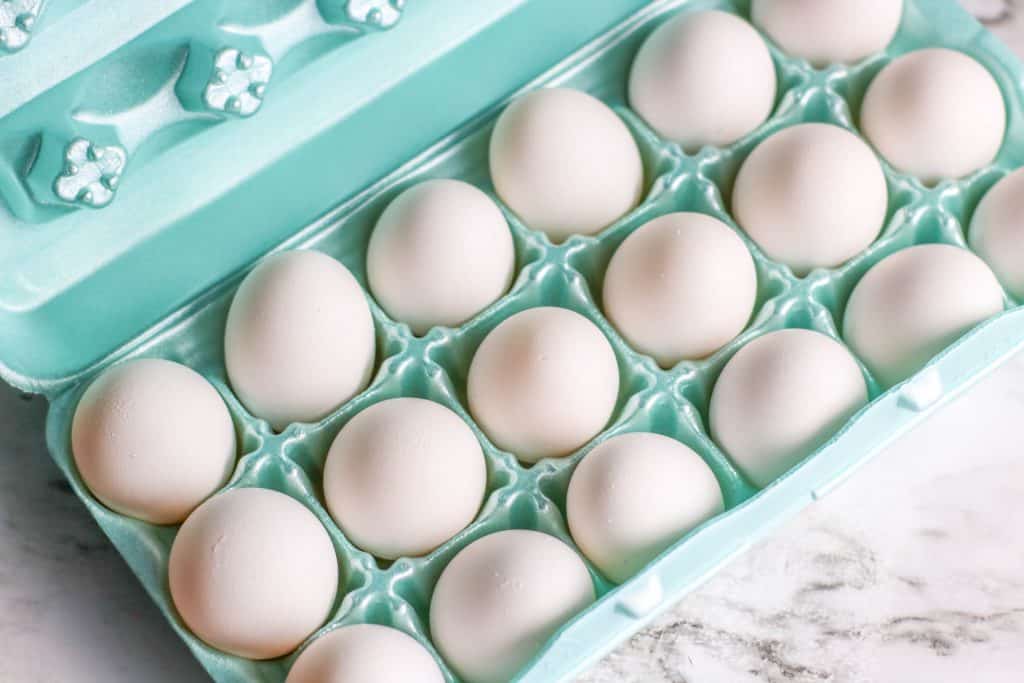 Eggs in a green styrofoam carton.