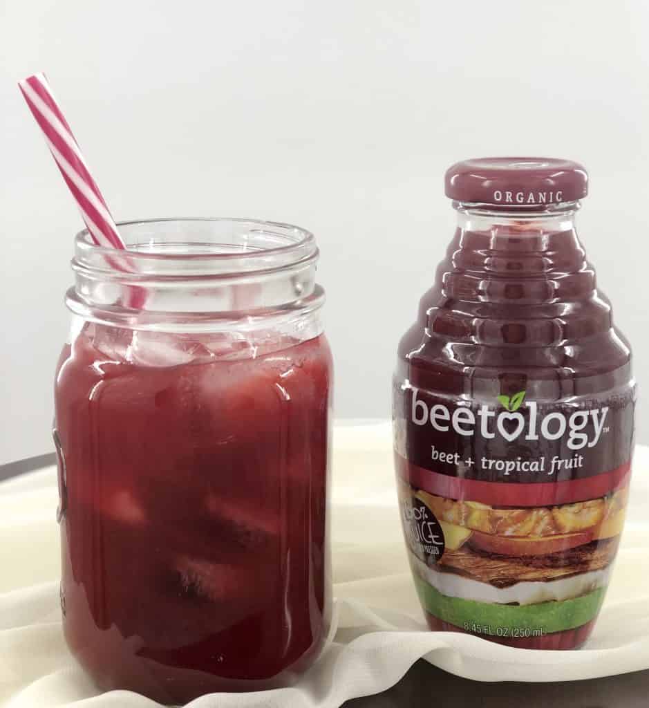 Beetology Juice and glass of it with a straw.