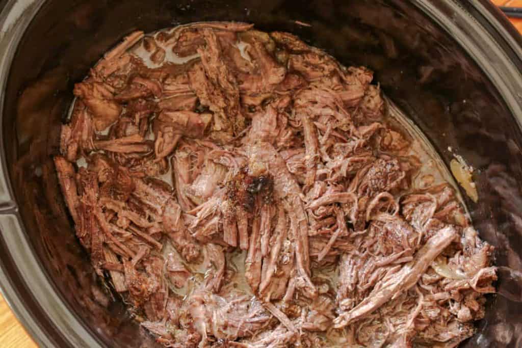 French dip beef and au jus in a crock pot.
