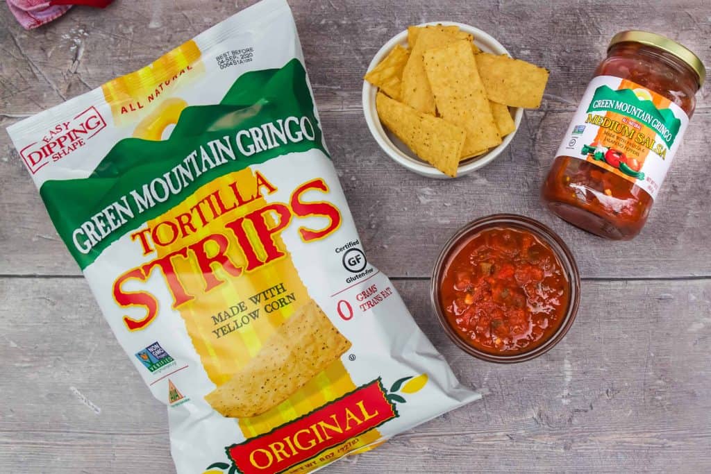 Green Mountain Gringo Tortilla Strips and Salas on a wood background.