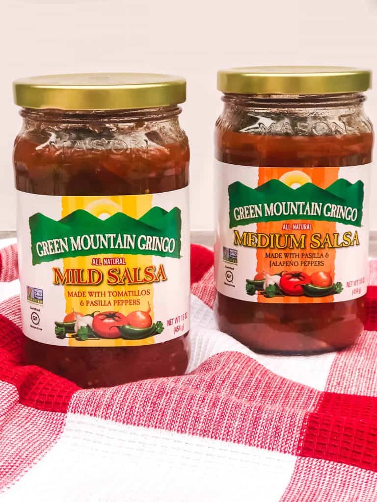 Head on shot of Green Mountain Gringo Mild and Medium Salsa on a red checked dish towel.