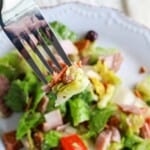 salad with meat on a white plate.