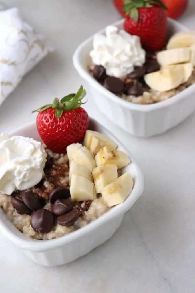 Instant Pot Oatmeal with Banana Split toppings served in 2 white bowls.
