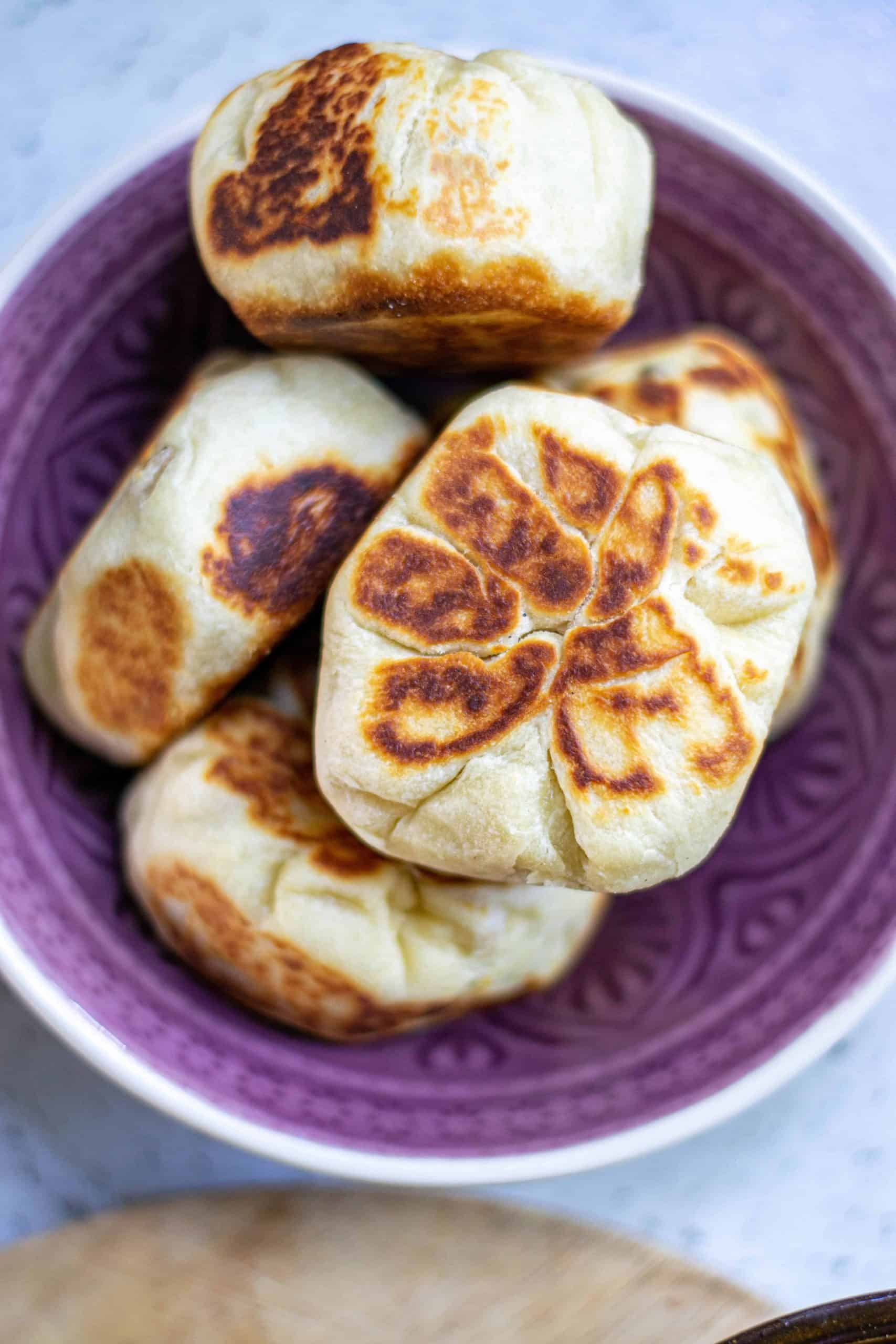 Vegan Bao Buns on a purple plate.