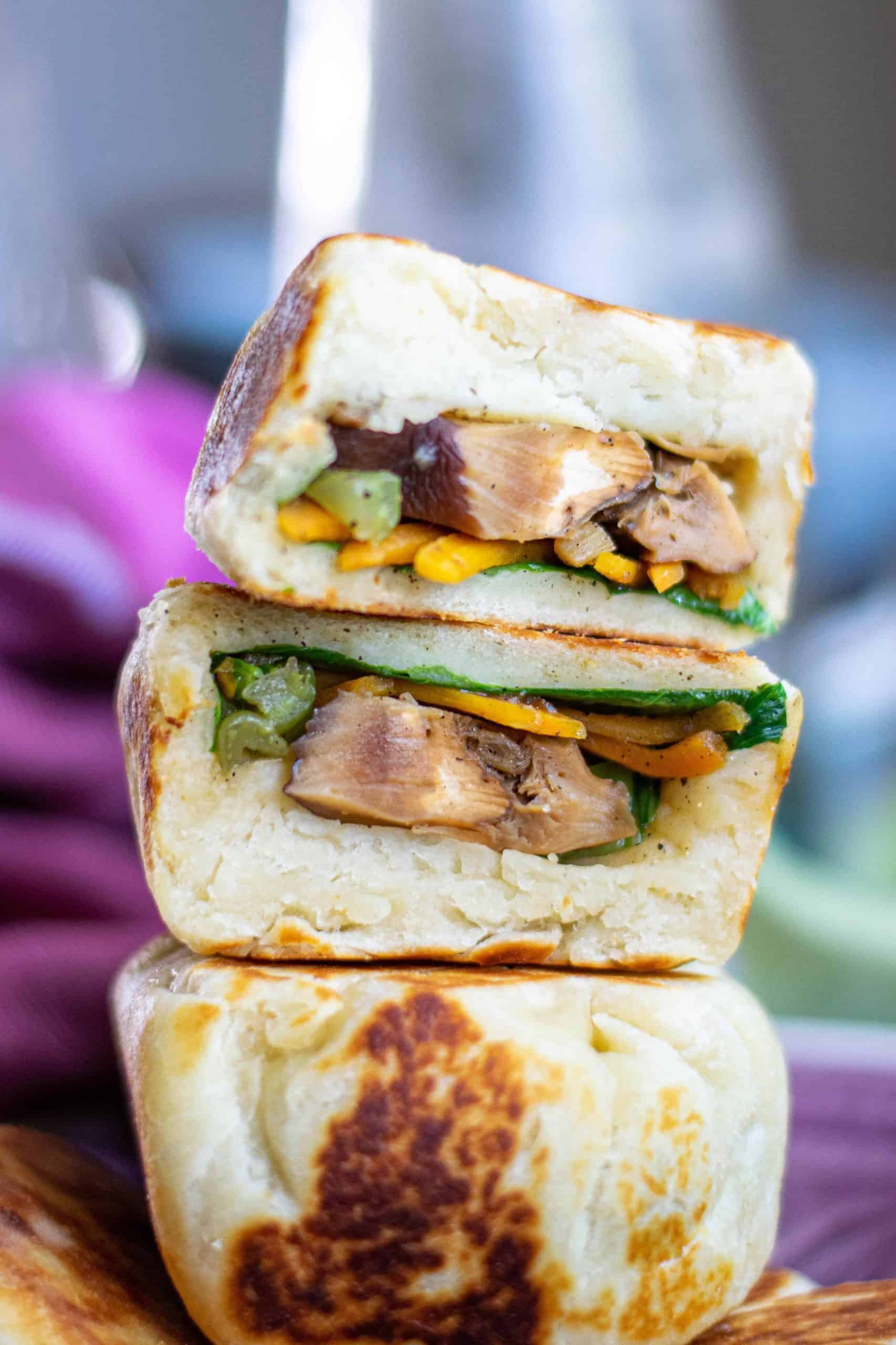 Easy Vegan Bao Bun Recipe with Bao Buns stacked on a purple plate.