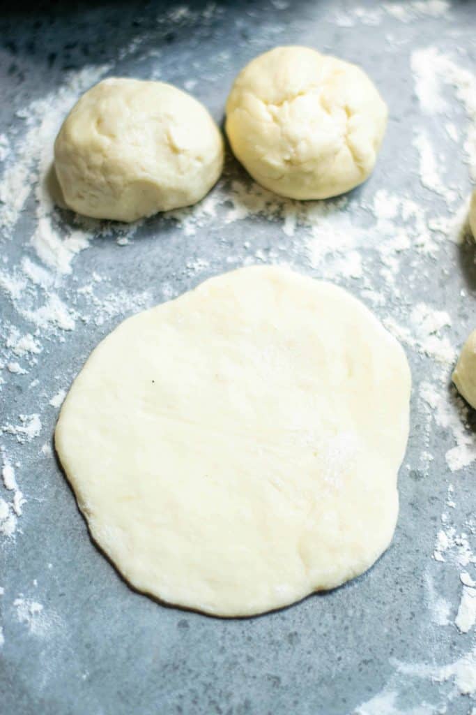 Bun dough rolled out and 2 dough balls move it.