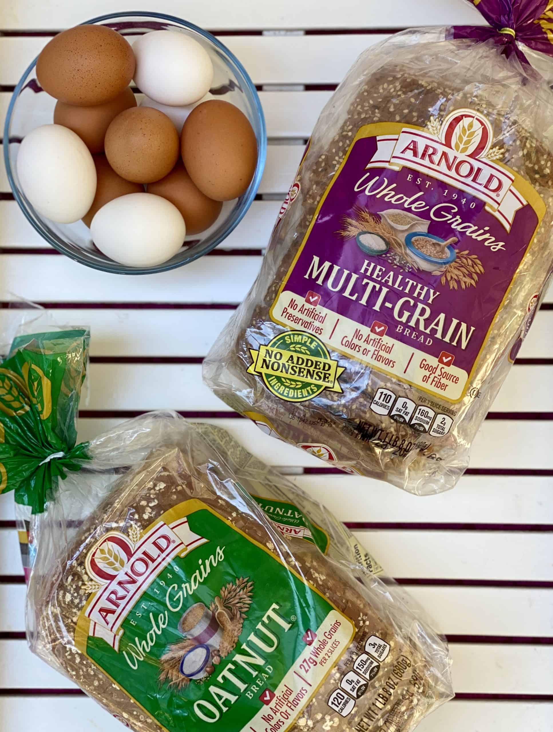 Arnold Healthy Multigrain Bread and Arnold Oatnut Bread with glass bowl of eggs in upper lefthand corner