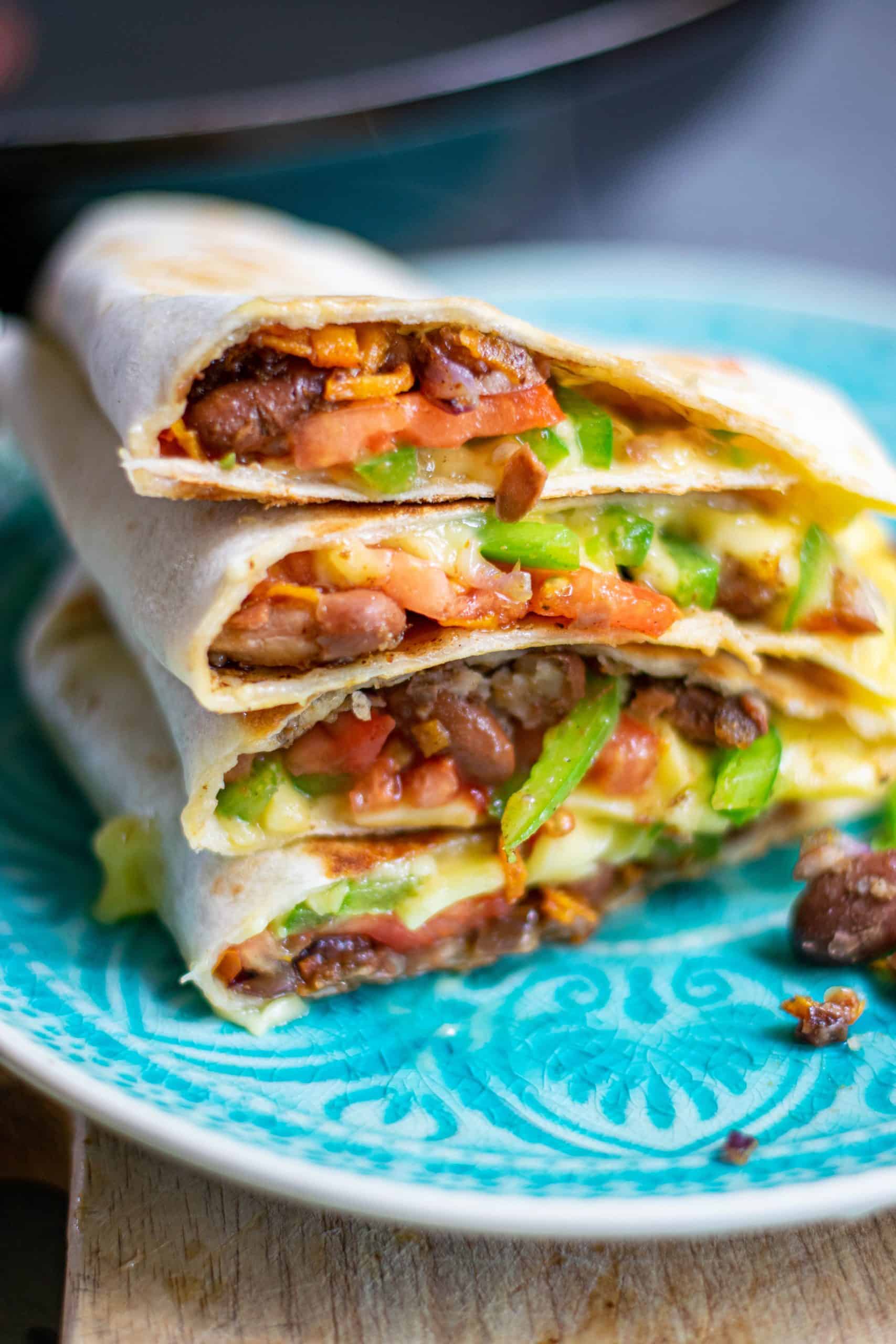 Quesadillas stacked on a blue plate.