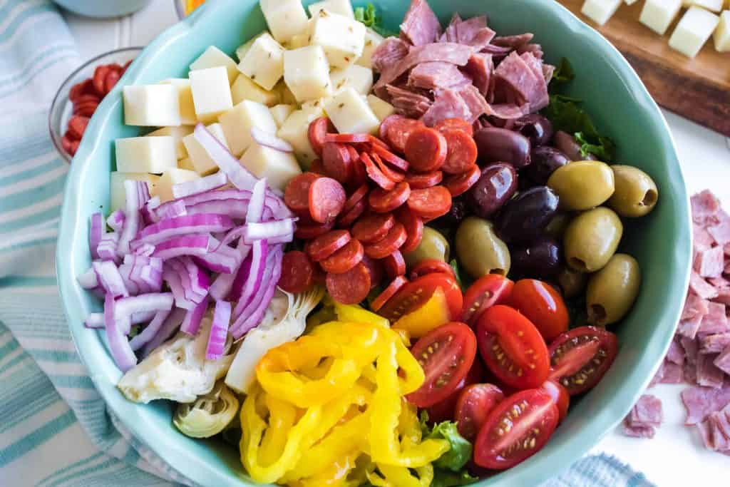 Antipasto salad in a blue bowl.