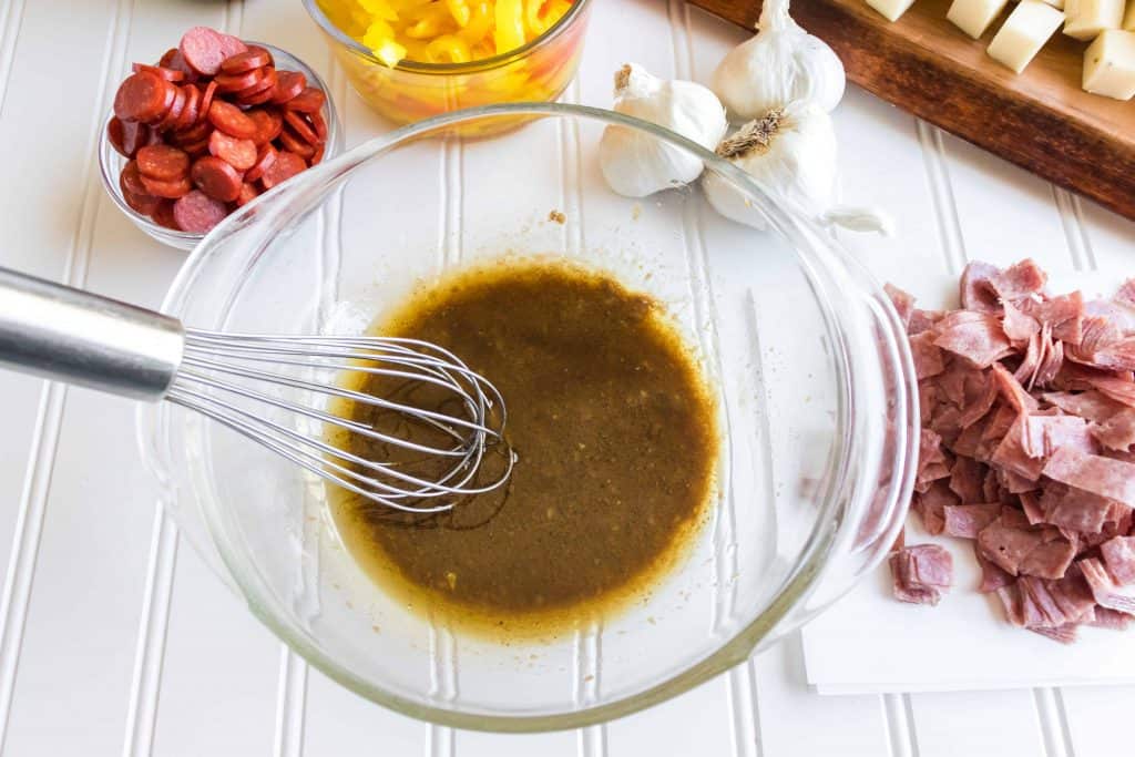 Salad Dressing with whisk in center of the bowl.